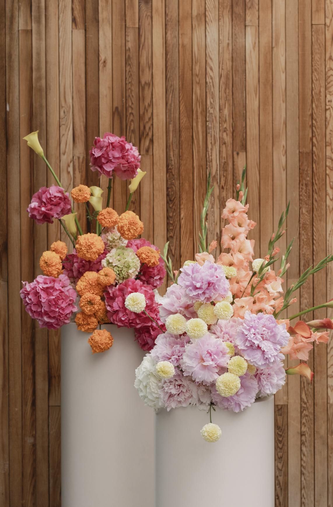 Bright and colourful ceremony flowers on plinths