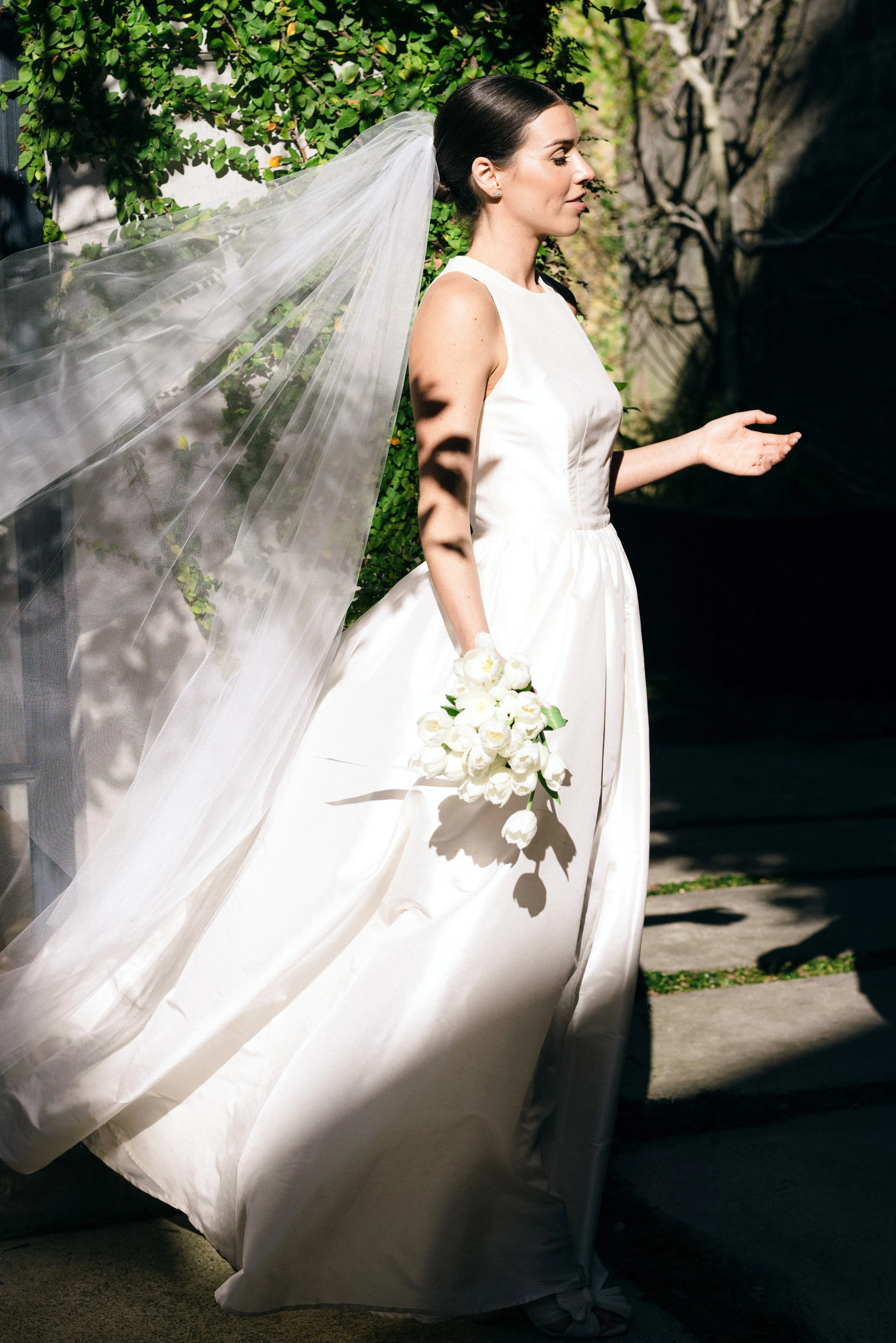 Bride holding an all white tulip bridal bouquet