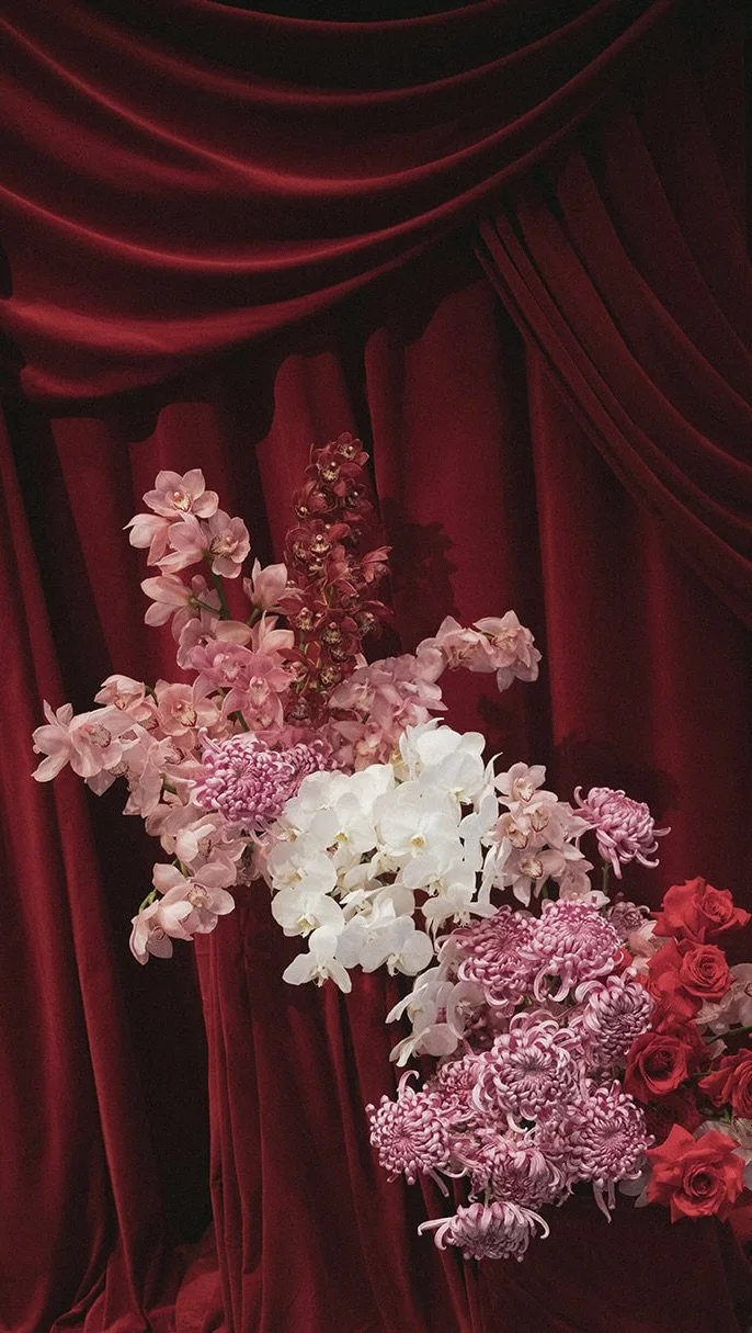 Pink cymbidiums and red rose installation