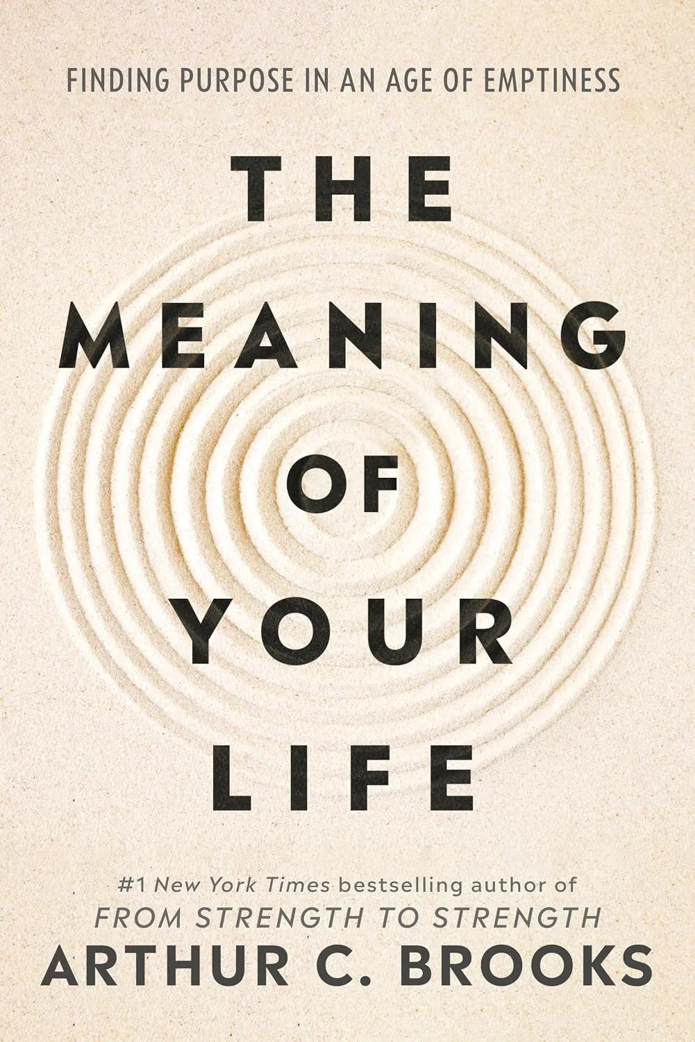 Book cover titled "The Meaning of Your Life" by Arthur C. Brooks, with a background of concentric circles in beige tones.
