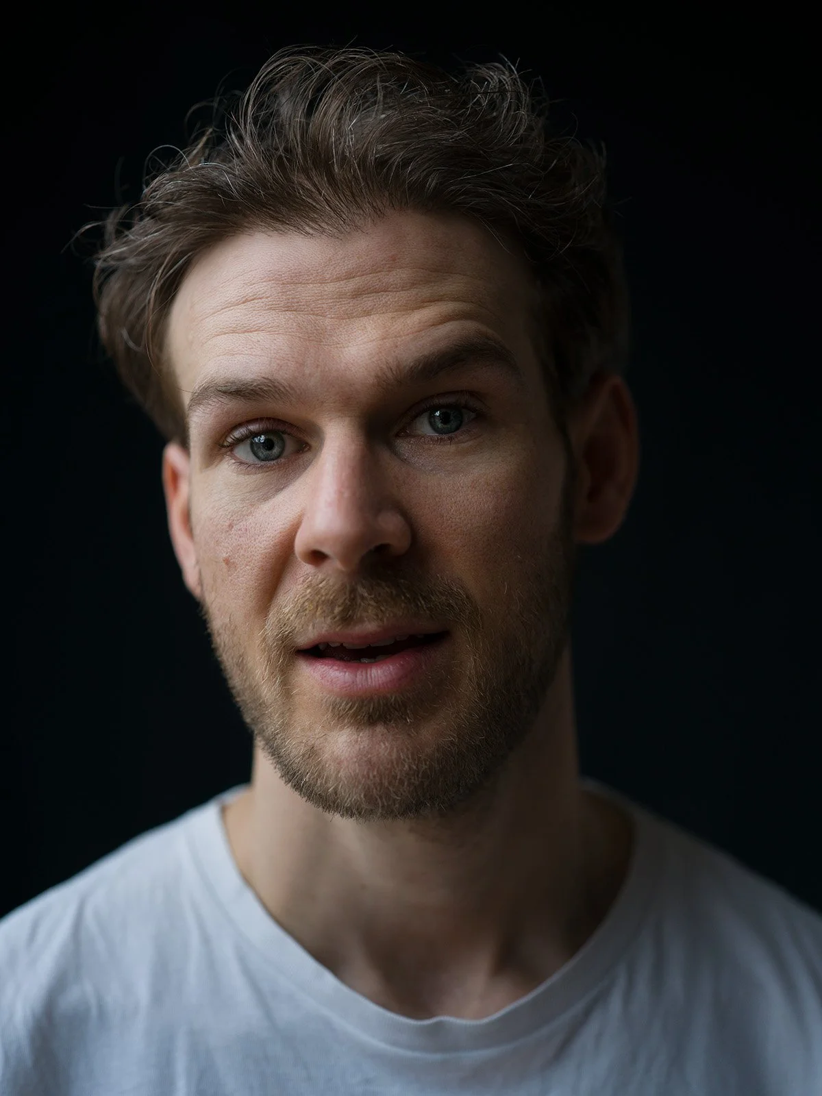 Professional headshot on dark background by Chris Mann London