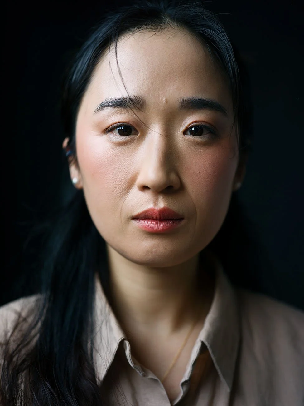 Professional headshot on dark background by Chris Mann London