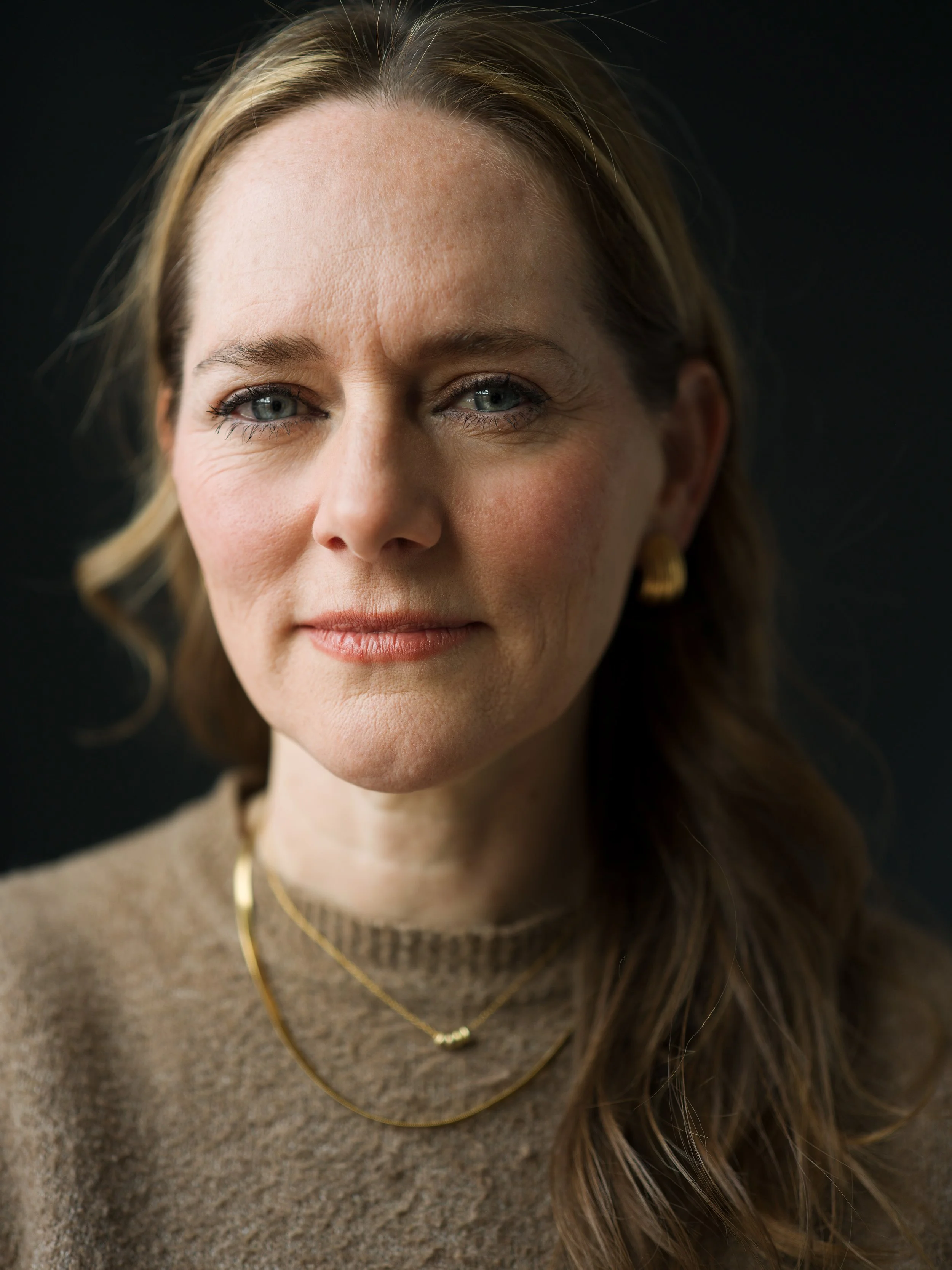 Professional headshot on dark background by Chris Mann London
