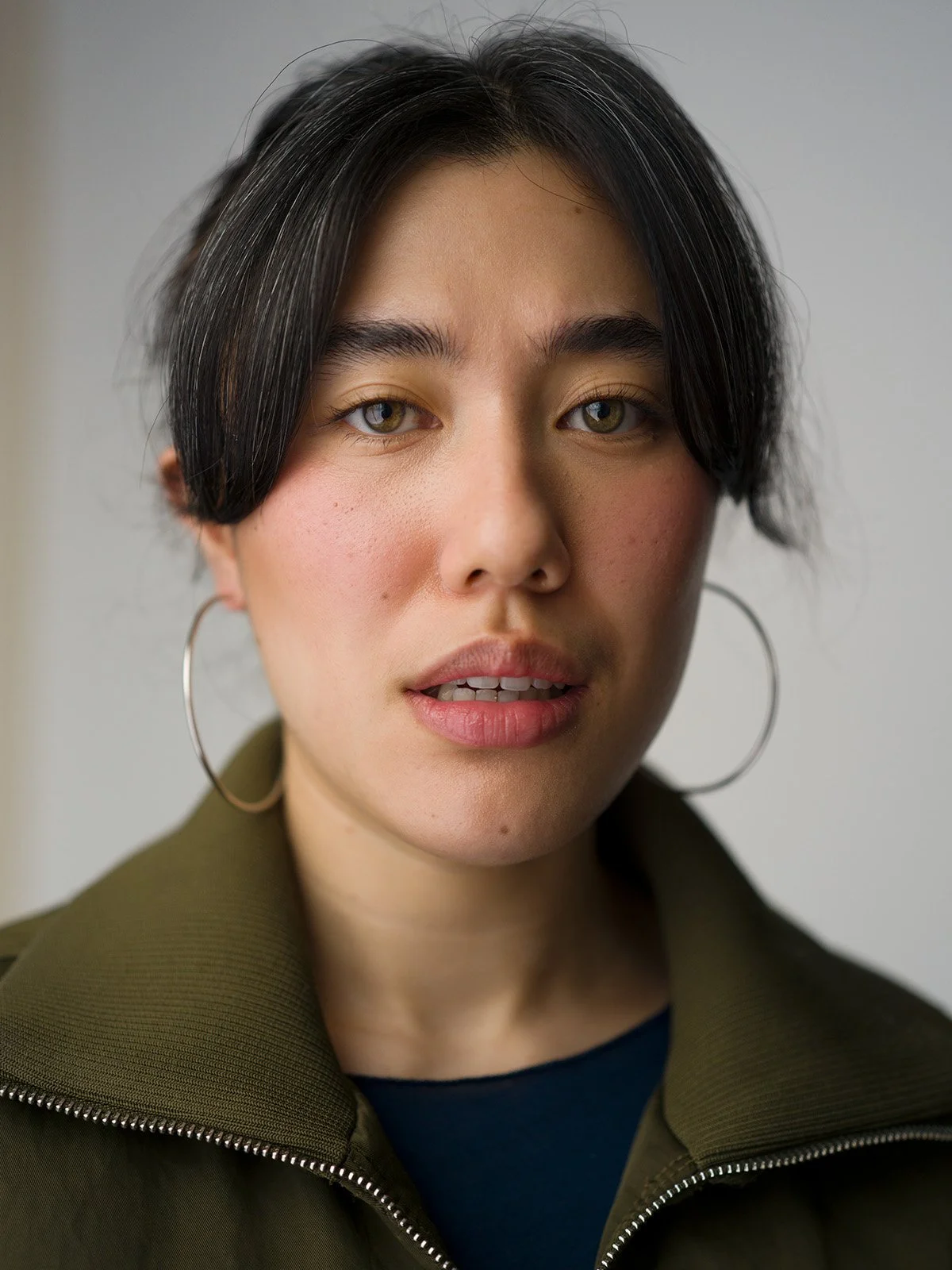 Professional headshot on plain background by Chris Mann