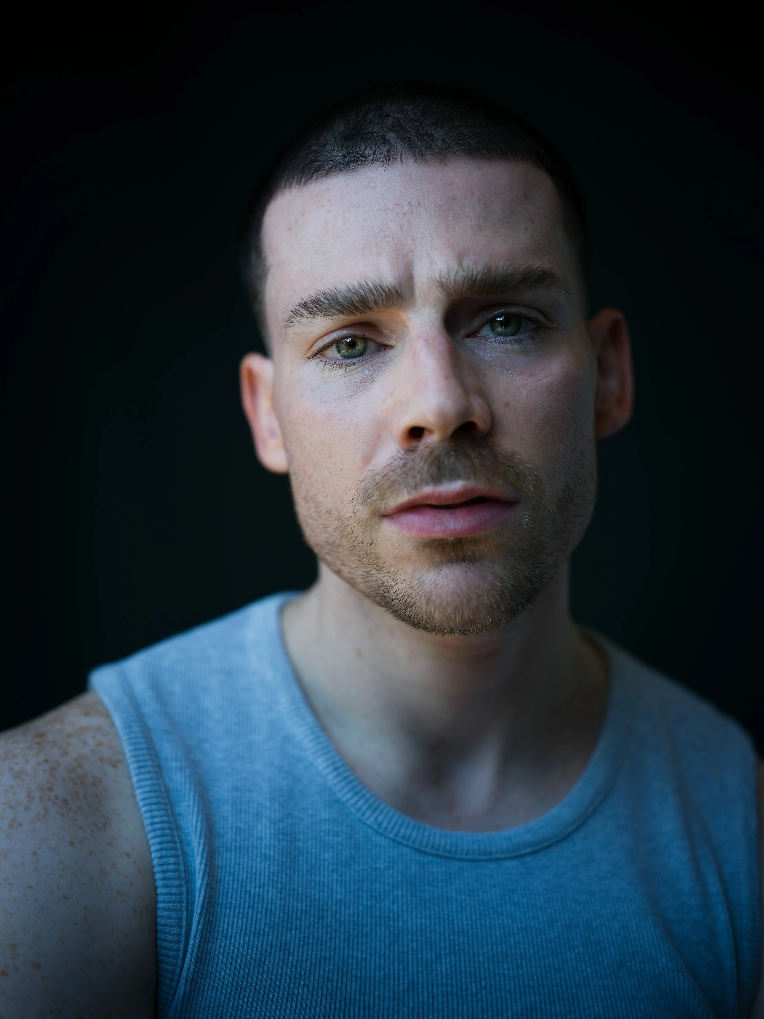 Headshot taken on a dark background by Chris Mann London