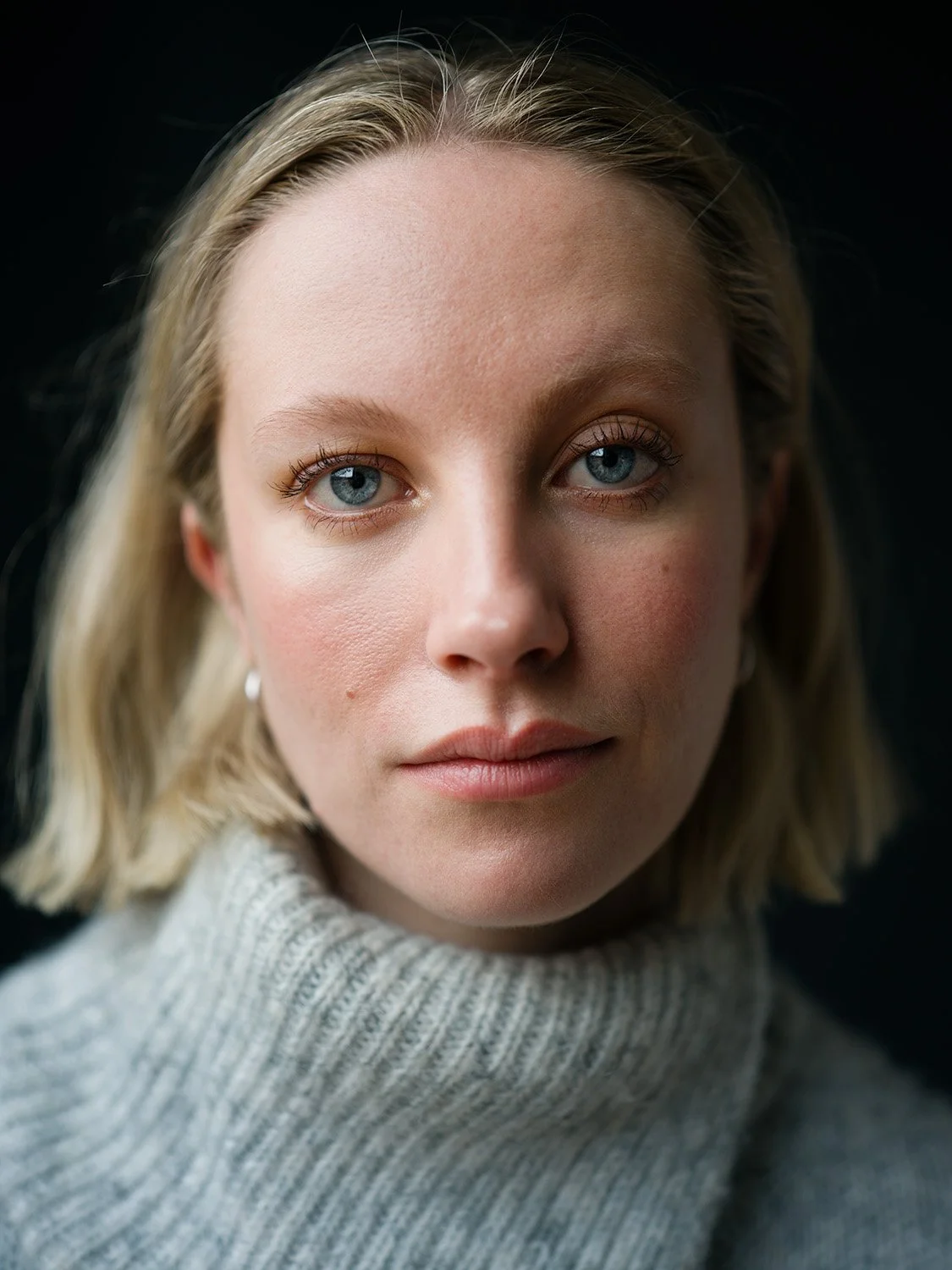 Professional headshot on dark background by Chris Mann London