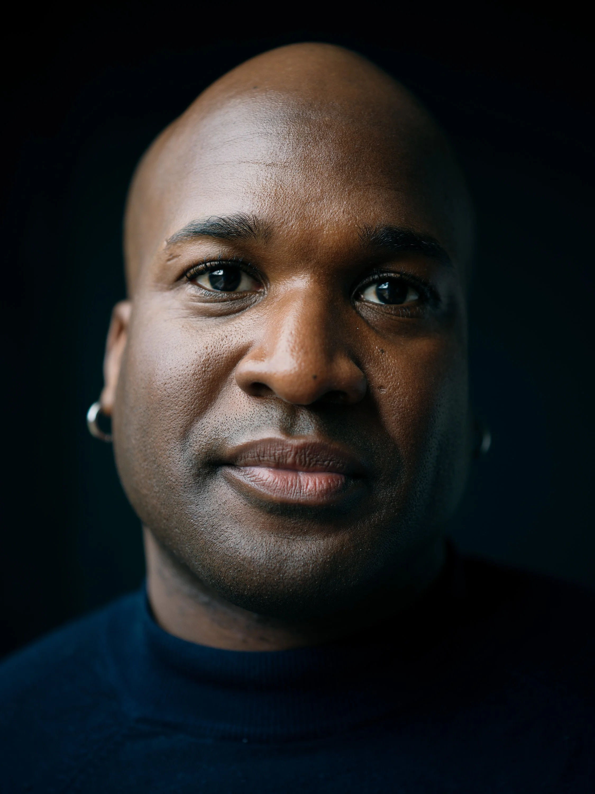 Professional headshot on dark background by Chris Mann London