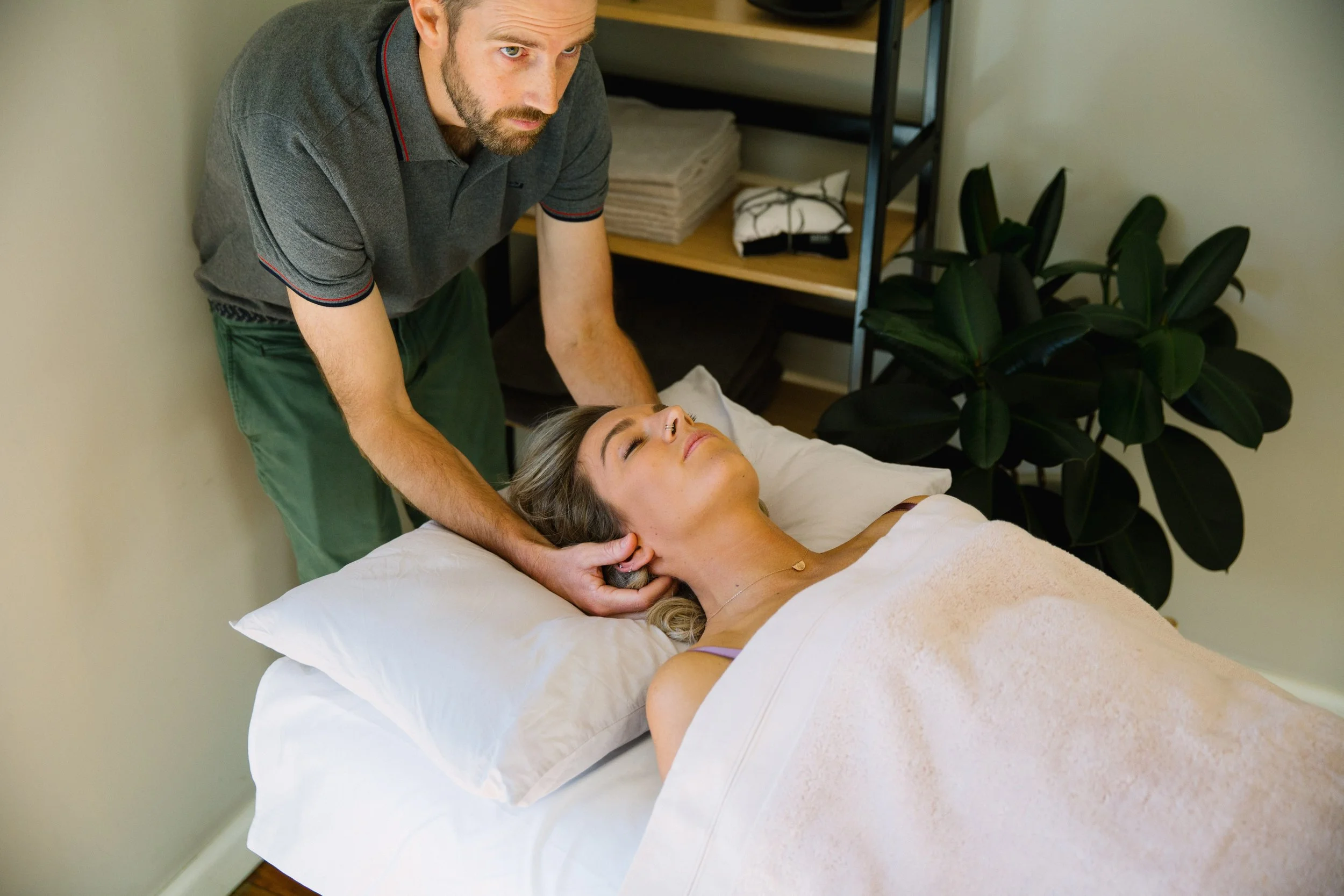 Osteopath providing hands-on treatment to a patient's neck