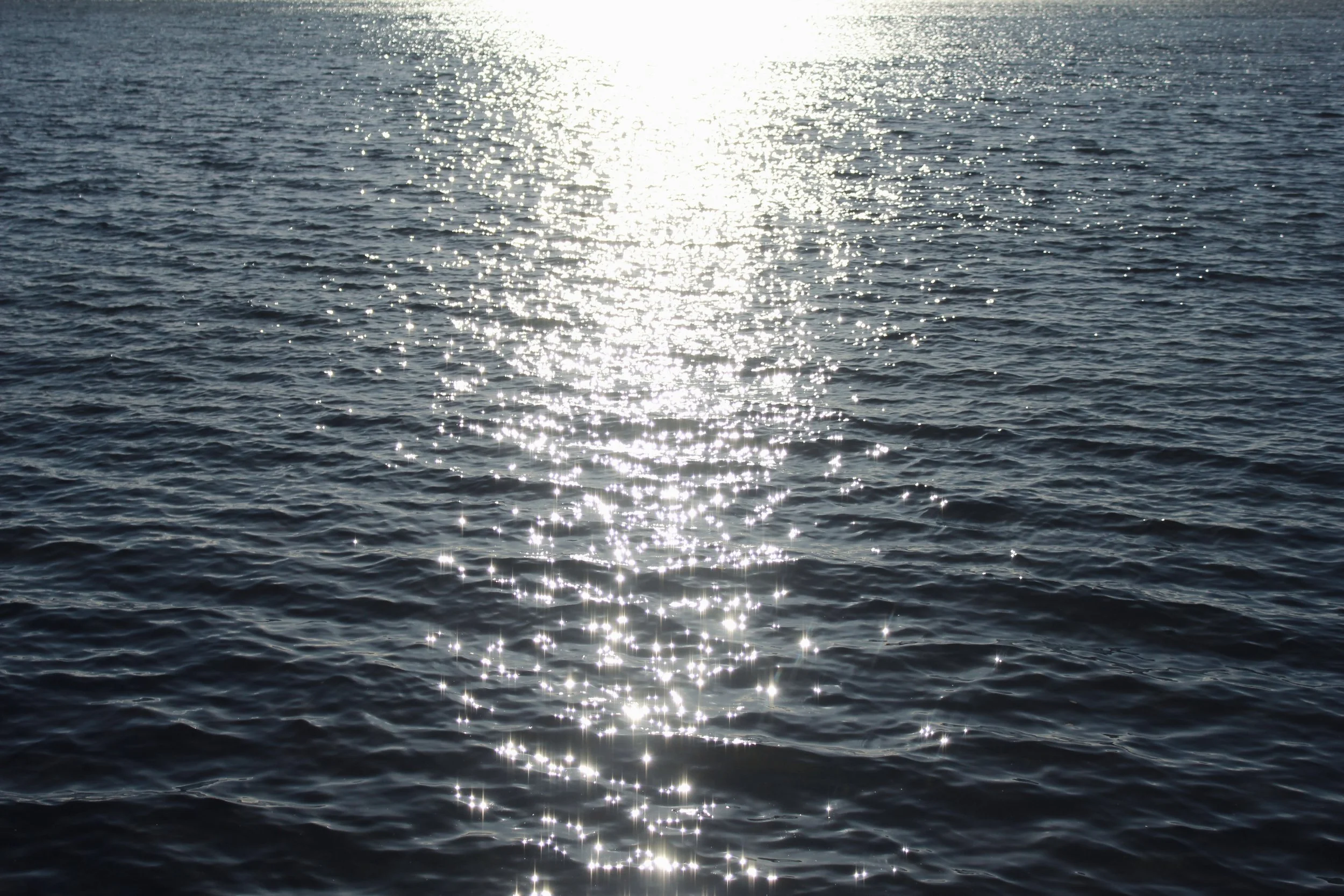 Sunlight reflecting on the surface of a calm ocean.
