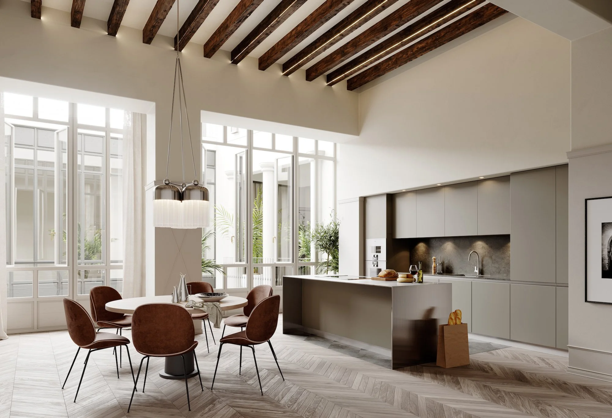 Modern kök och matsalsområde med stora fönster, trägolv i fiskbensmönster, matbord med åtta bruna stolar, kök med grå skåp och vitt köksö i projektet Impremta Garden i Spain