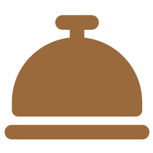 A brown service bell with a rounded top and a knob on top.