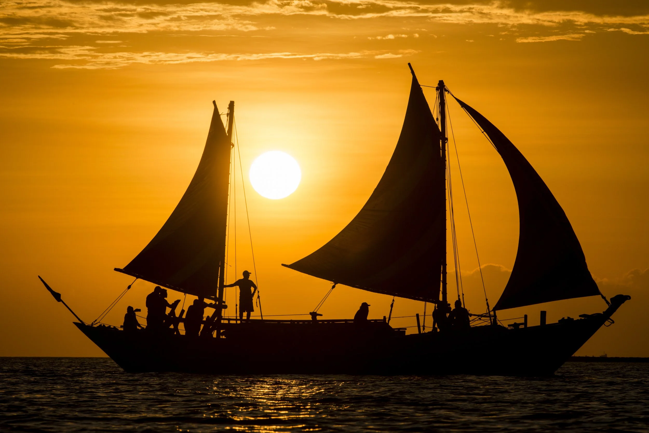 A replica 18-meter wooden balangay boat sails in Manila Bay.