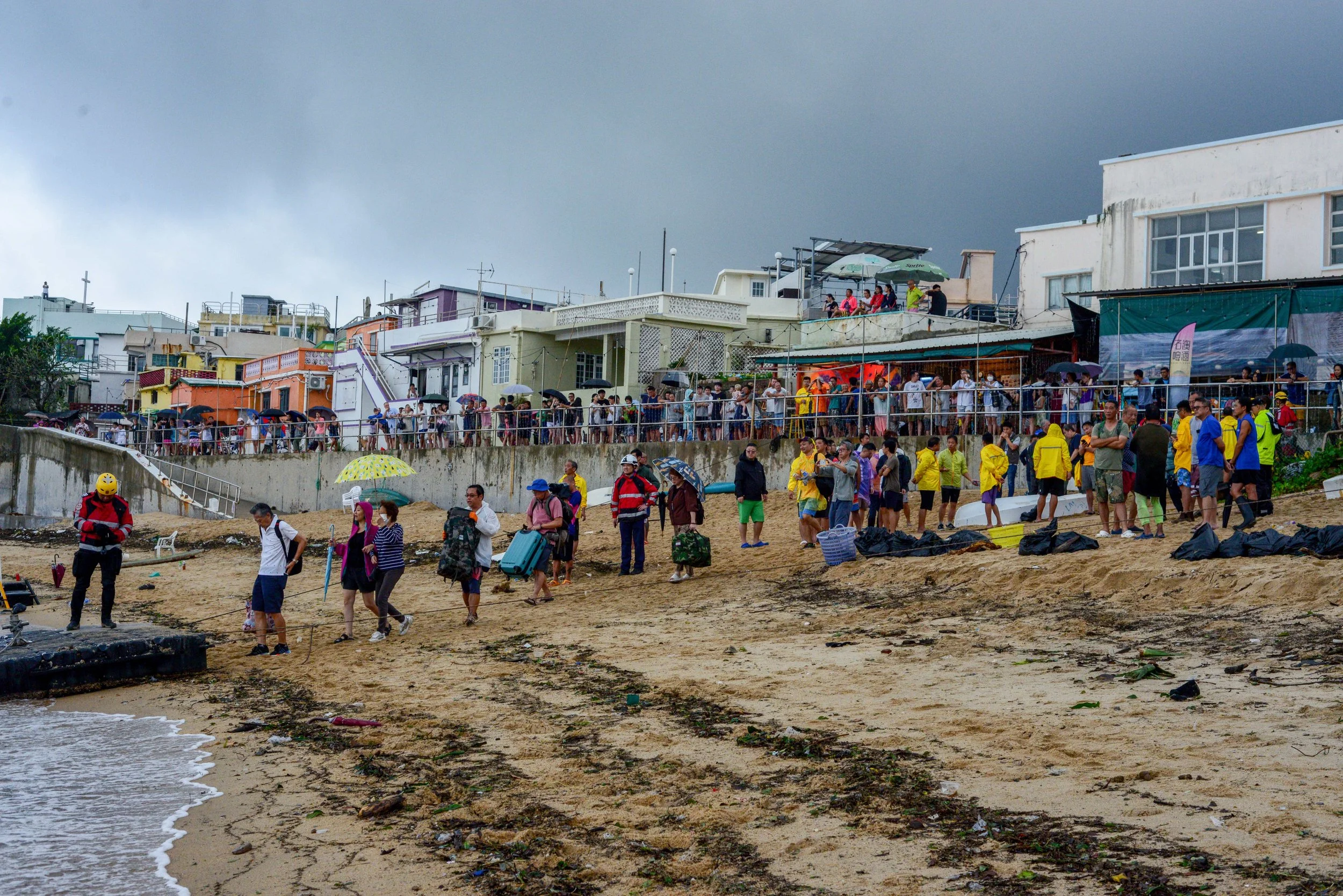 Residents are evacuated by various government departments by boat, after torrential rain days previously caused landslides on the only road connecting Shek O village to the city, in Hong Kong on 09 September 2023.