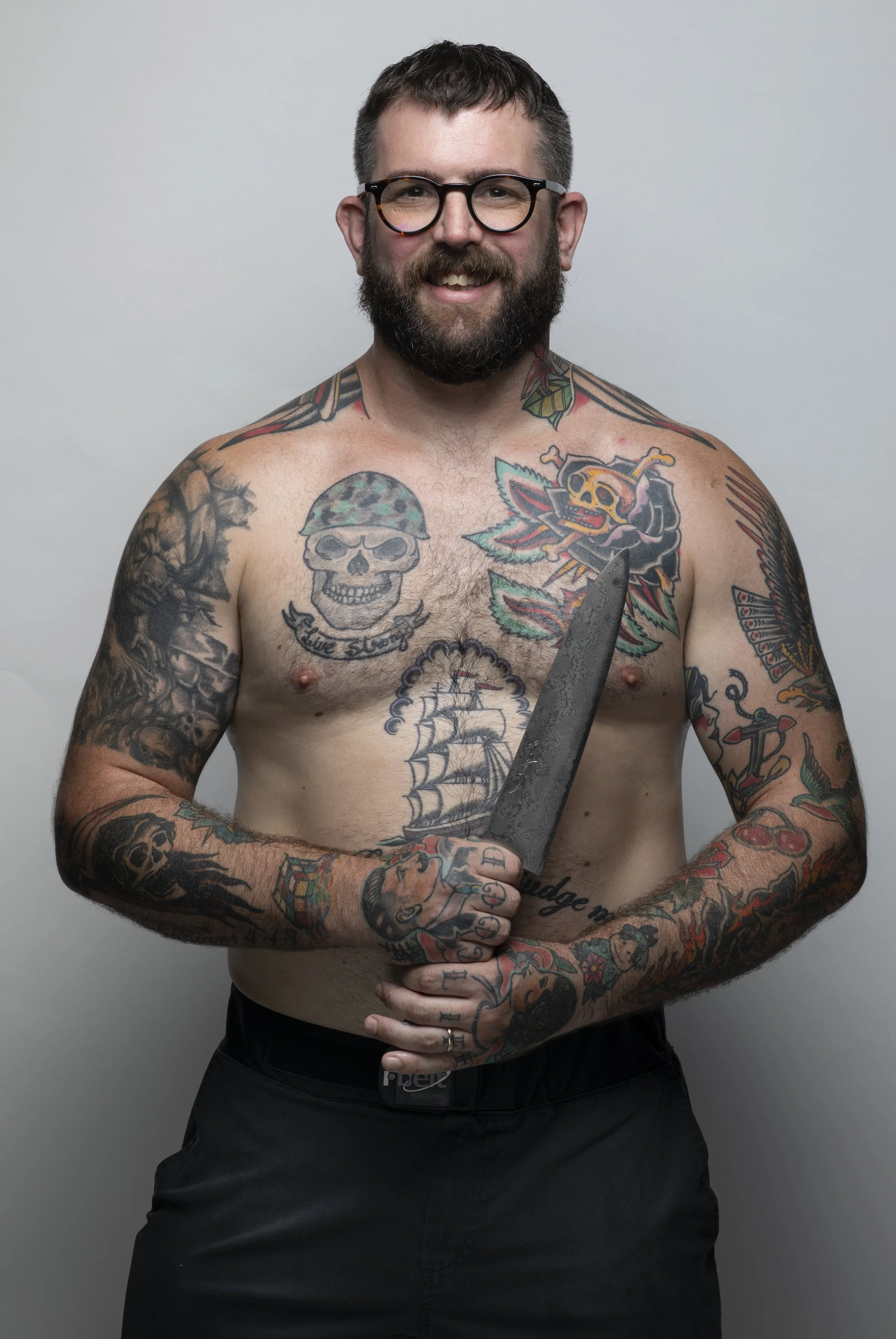 The well tattooed Chef Nate Green holding his favourite knife.
