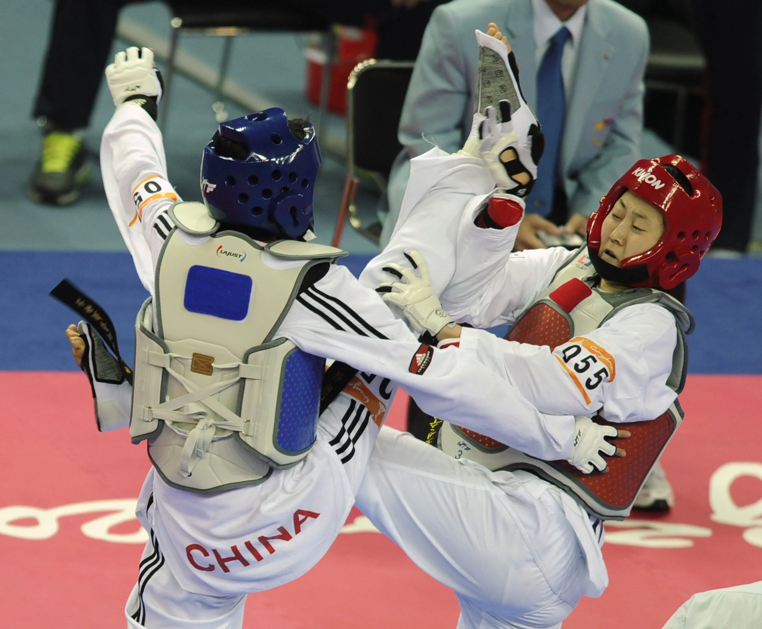 Lee Sung Hye of South Korea fights with Hou Yuzhou of China during the women's under 57 kg Taekwon-do final at the Guangdong Stadium in Guangzhou during the 16th Asian Games on November 18, 2010.