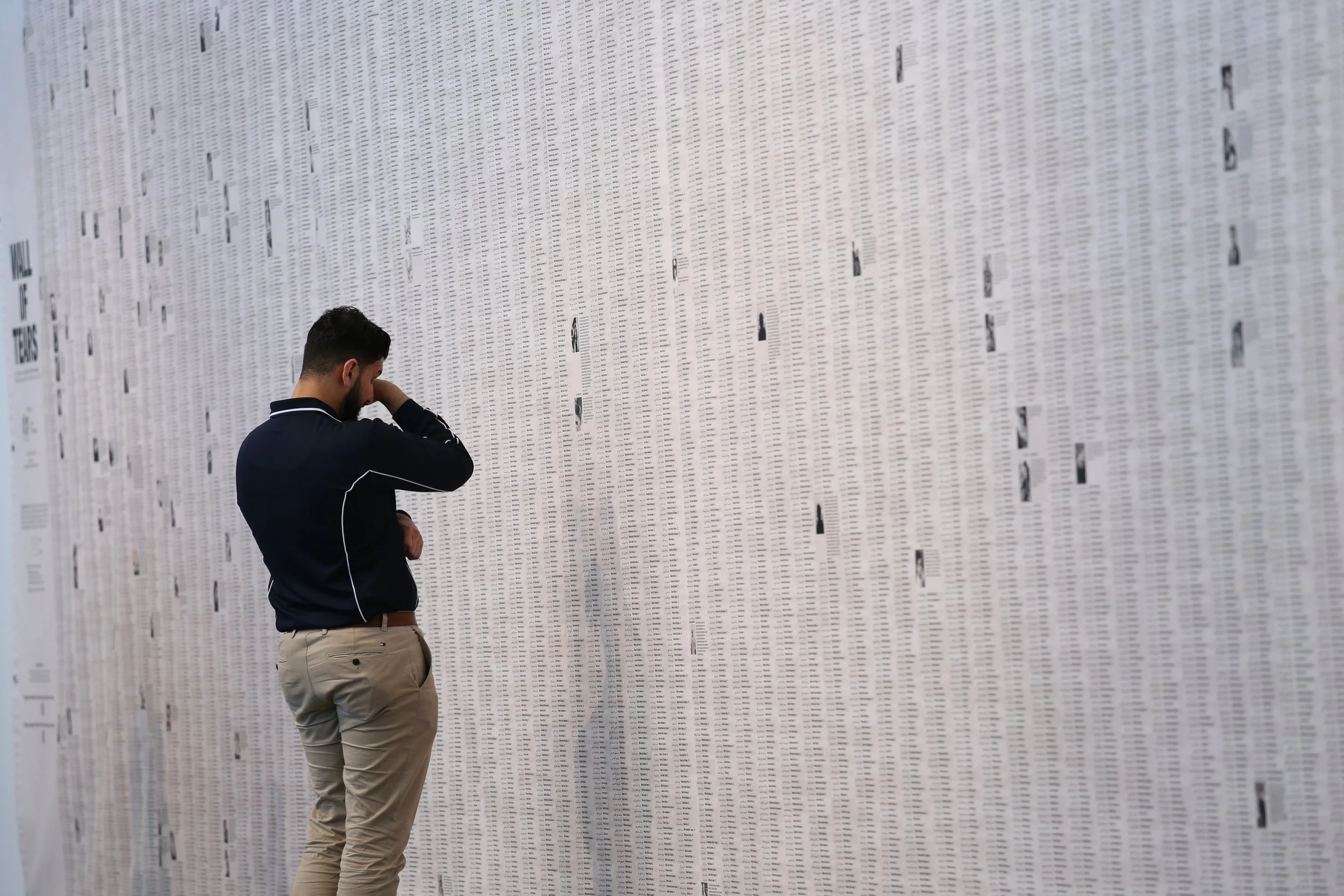 An attendee reacts as he looks at the Wall of Tears, on display at the Holmes a Court Gallery in Perth, Western Australia on July 23, 2026. The display by US artist Phil Buehler is a memorial to the 18457 children killed in Gaza between October 2023 
