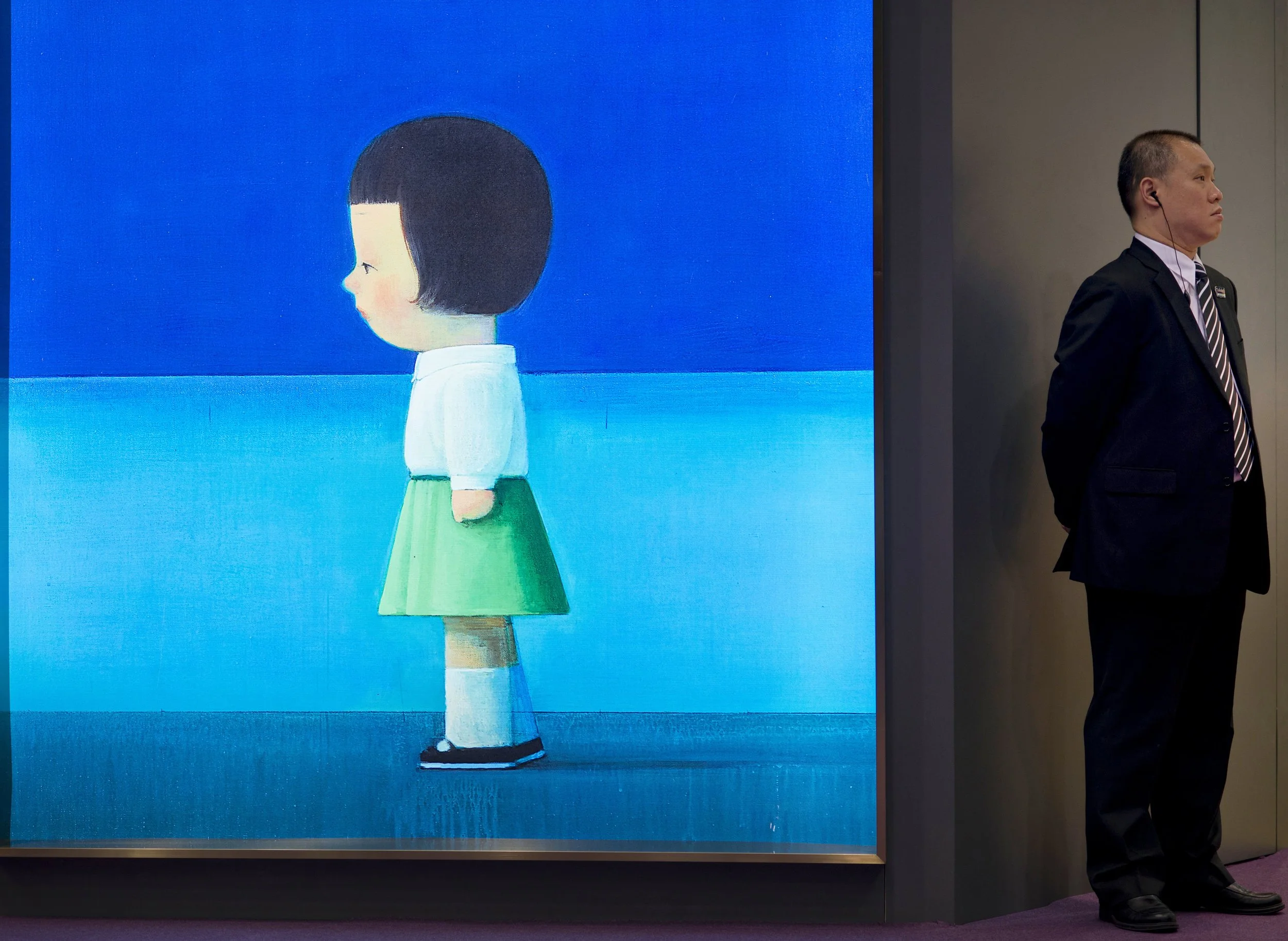 A security guard looks the other way as artwork, by Chinese artist Liu Ye,  "Hello, Mondrian" is displayed in Hong Kong