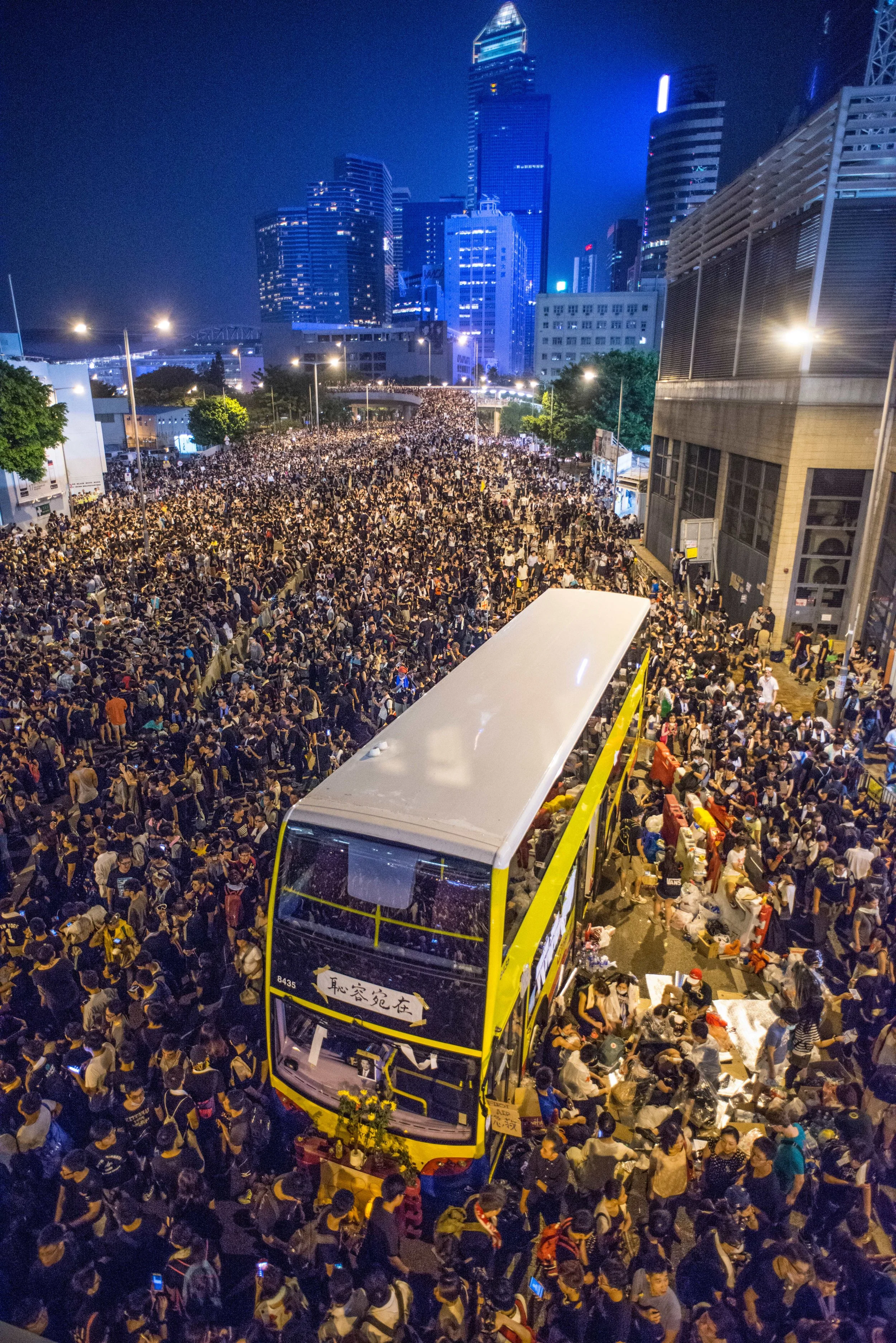 Protestors peacefully surround the streets as a bus is abandoned during the 2014 Umbrella Revolution in Hong Kong