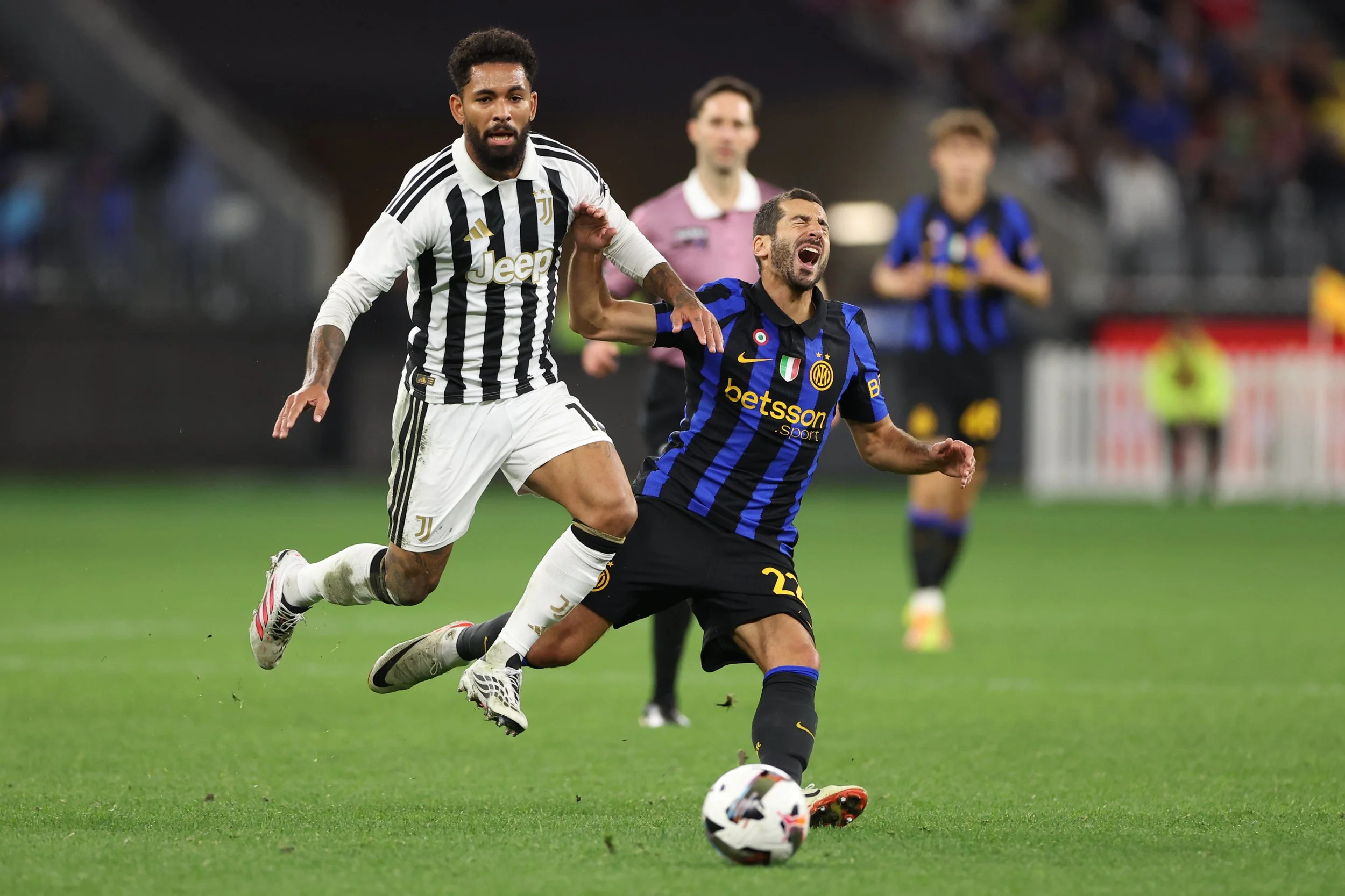 Inter Milan's Henrikh Mkhitaryan (R) of Inter Milan reacts as he fights for the ball with Juventus' Douglas Luiz (L) during the Derby d'Inter friendly match between Italian football giants Juventus and Inter Milan on Saturday, 8 August 2026.