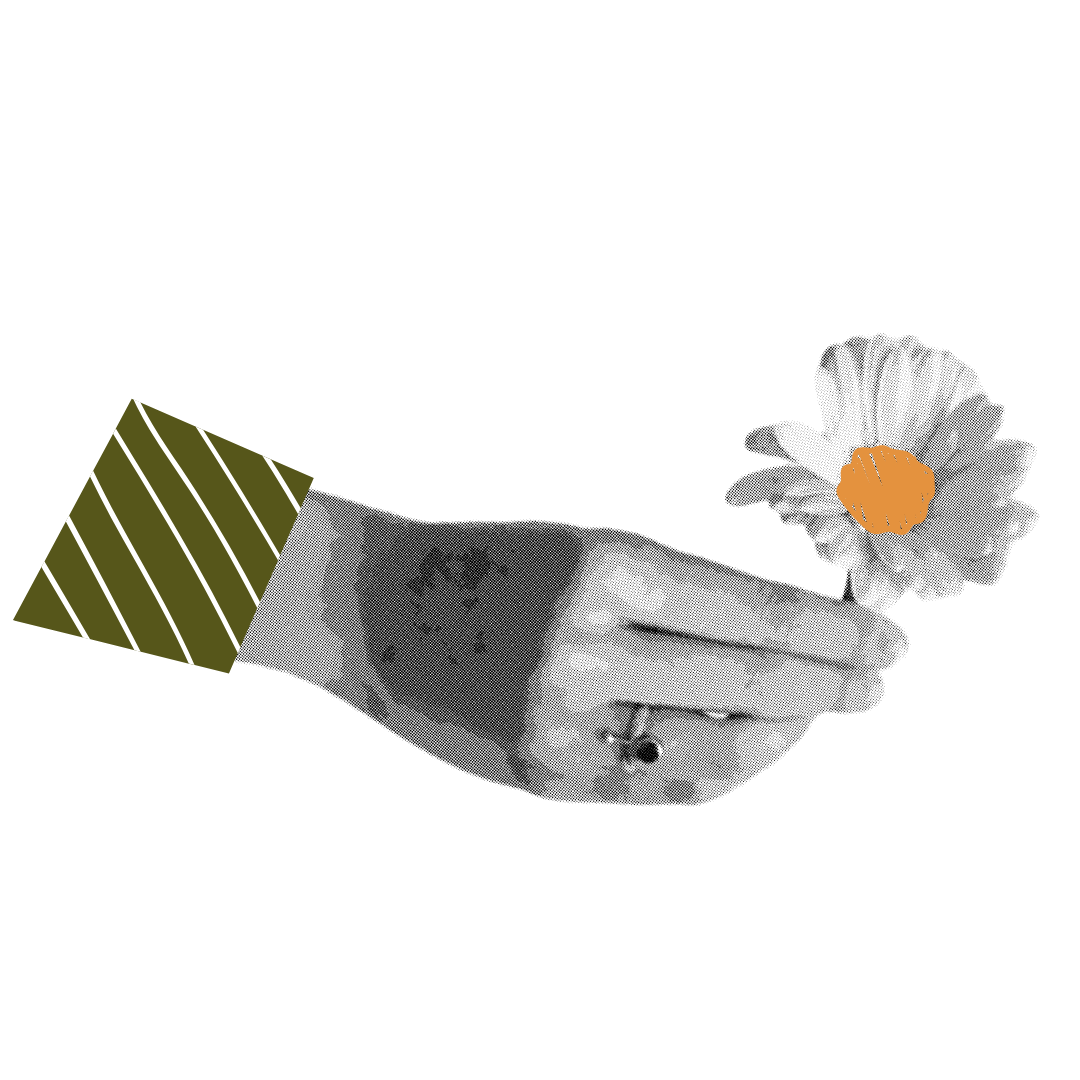 A hand holding a white flower with an orange center, with the arm wearing a dark sleeves and a ring on the finger, against a black background.