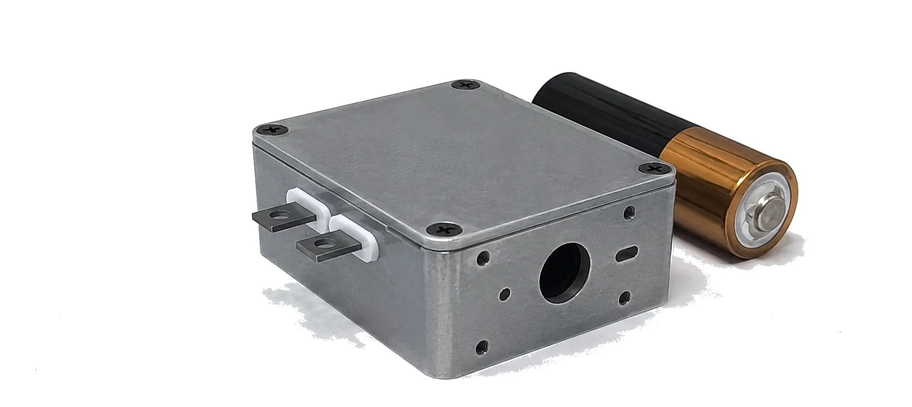A metal electric motor with wires and a battery on a white background.