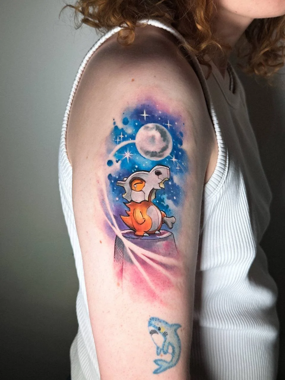 Illustrative character tattoo with soft color and sketch-style details by Maya Marina Tattoo.
