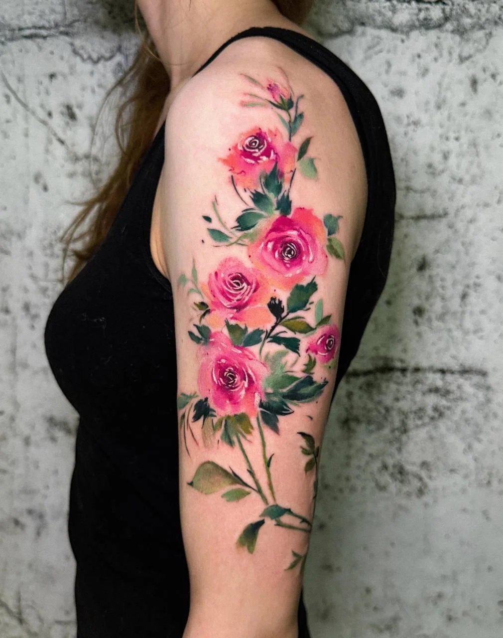 Pink watercolor rose tattoo on the shoulder by Maya Marina Tattoo.