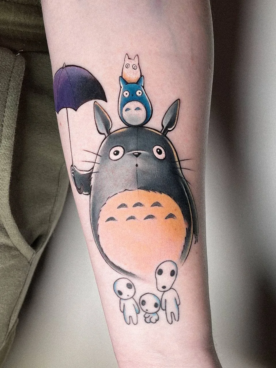 Totoro-inspired watercolor tattoo on the arm by Maya Marina Tattoo.