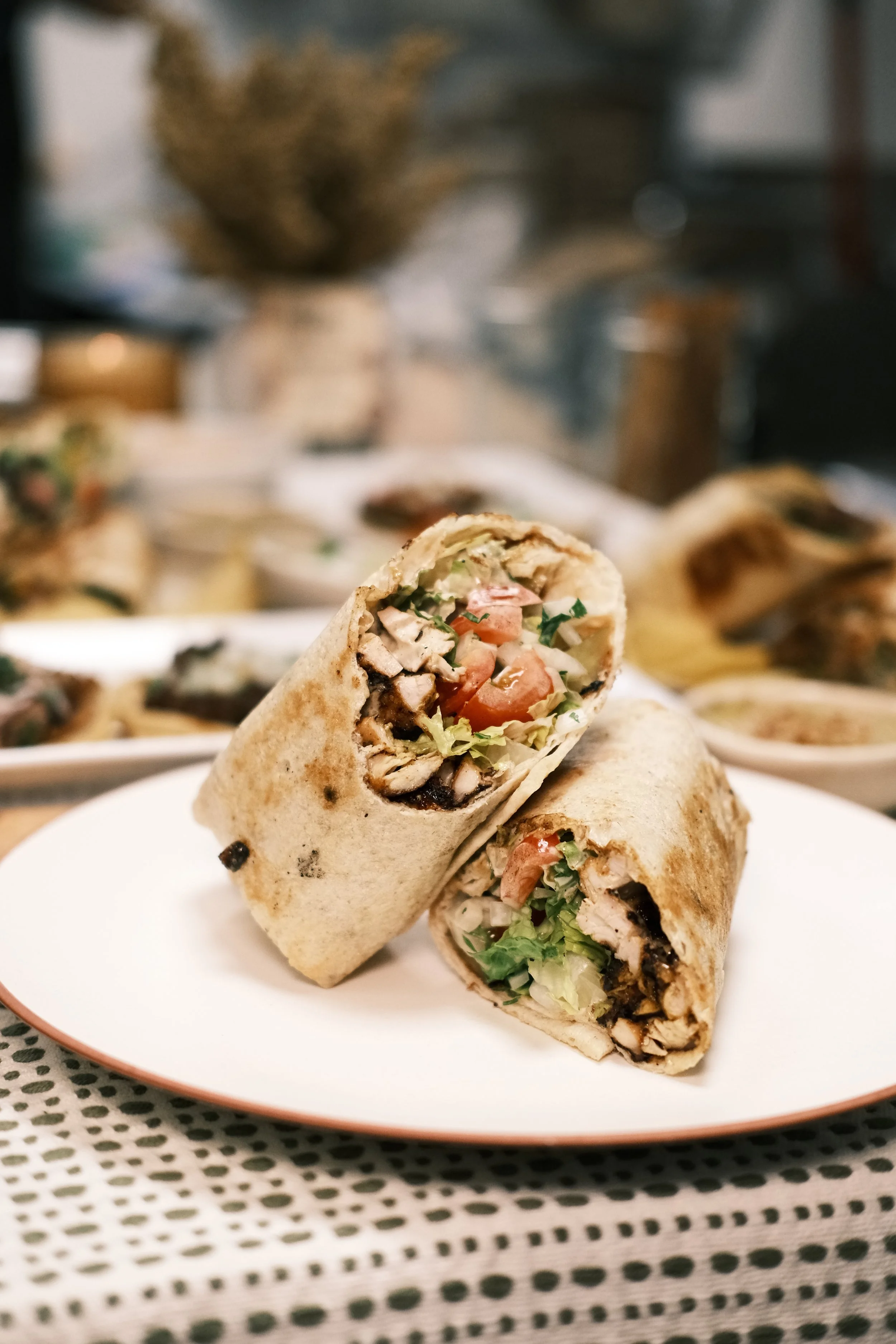 Grilled chicken shawarma wrapped in Iraqi bread with fresh vegetables.