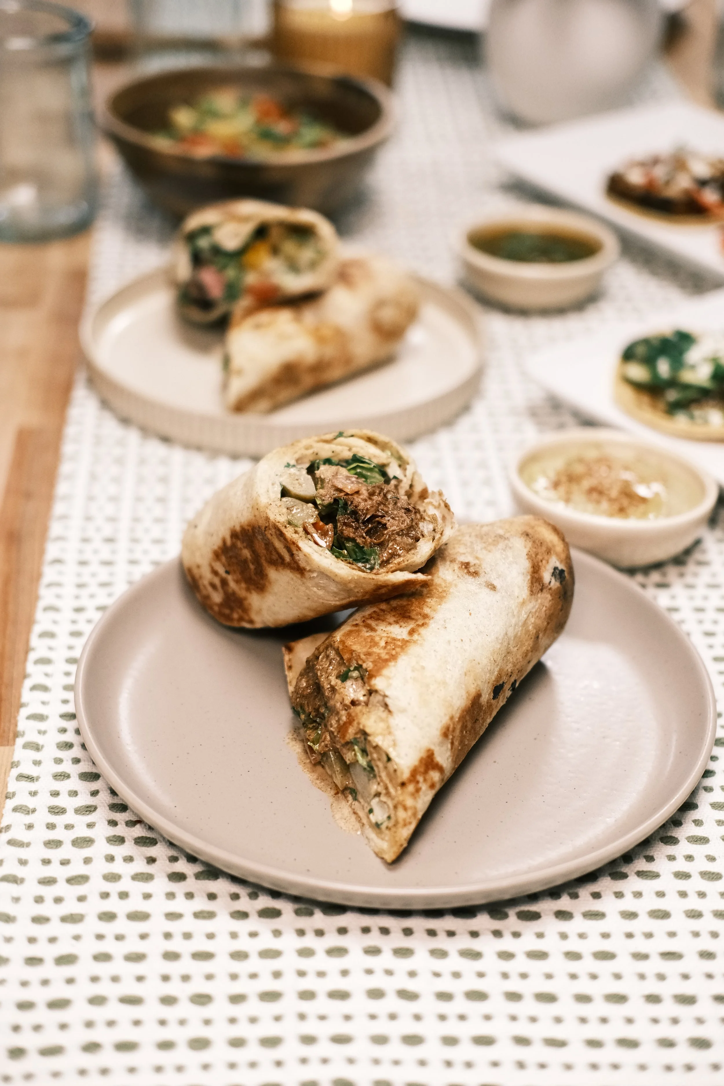Barbacoa shawarma wrapped in Iraqi bread with fresh vegetables.