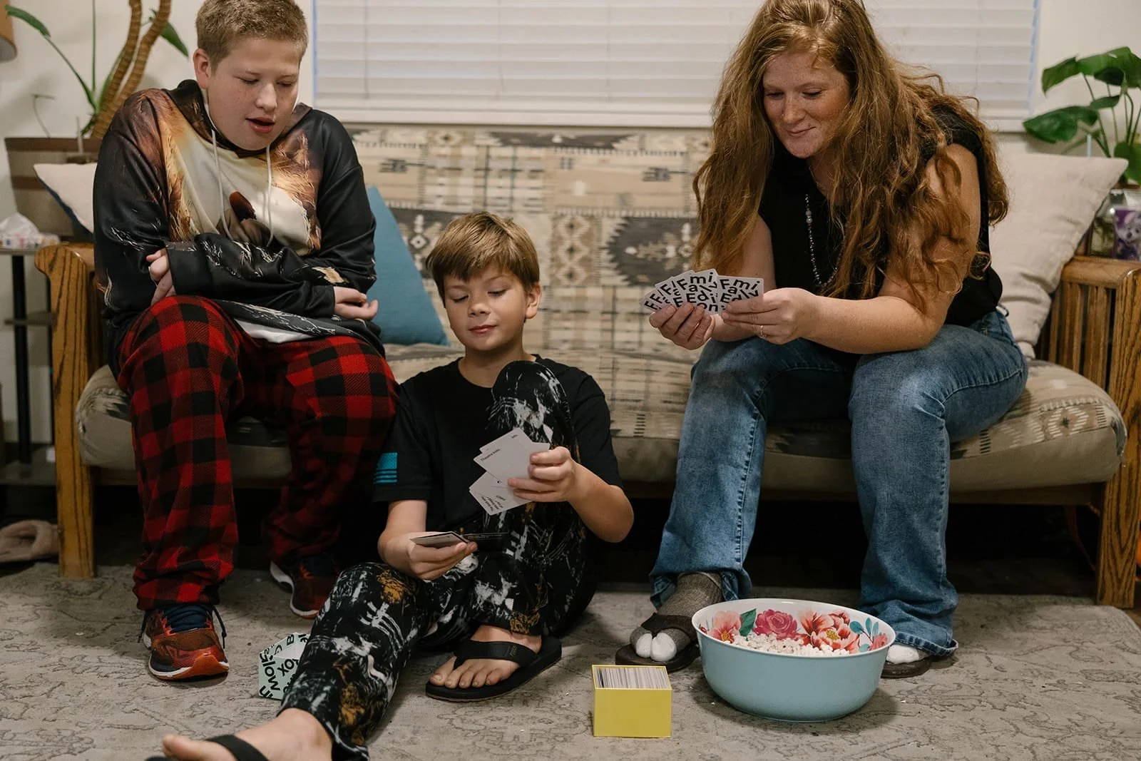 Community Frameworks housing resident playing cards with her children.