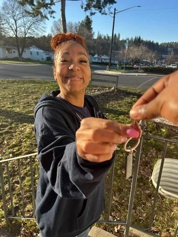 First-time homebuyer, Ericka, accepting keys to her new house.