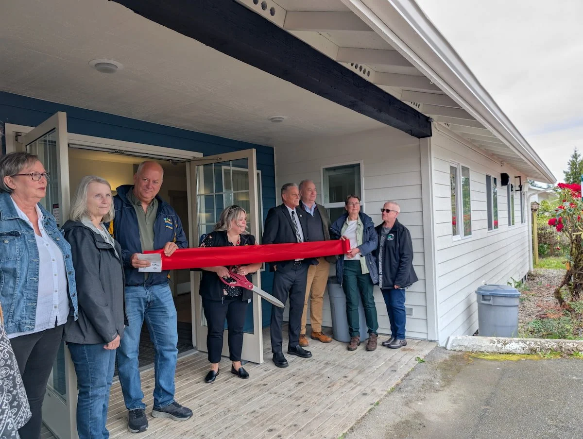 Community leaders at ribbon cutting ceremony for new affordable housing in the Northwest.