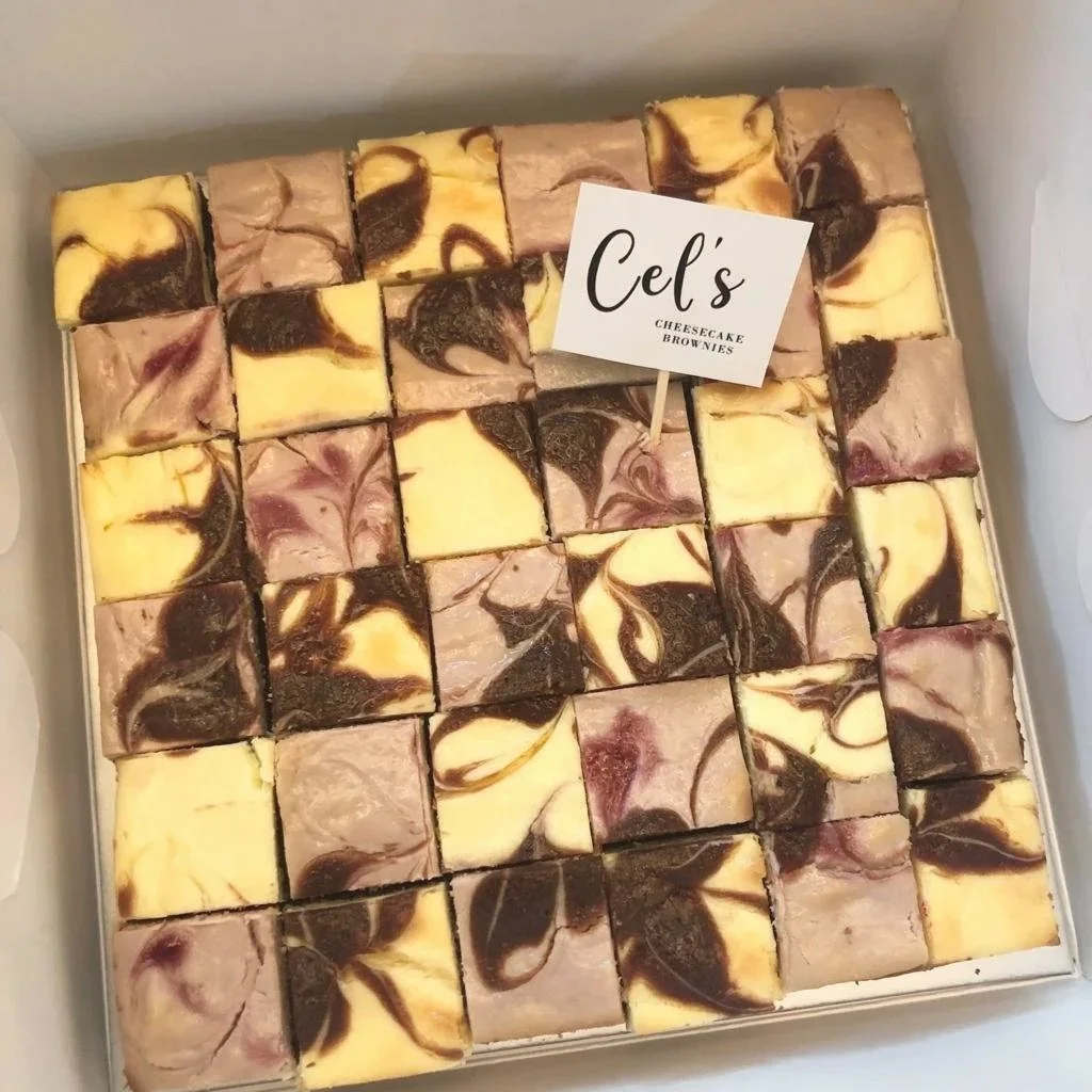A box of cheesecake brownies featuring a checkerboard of classic and mixed berries flavour