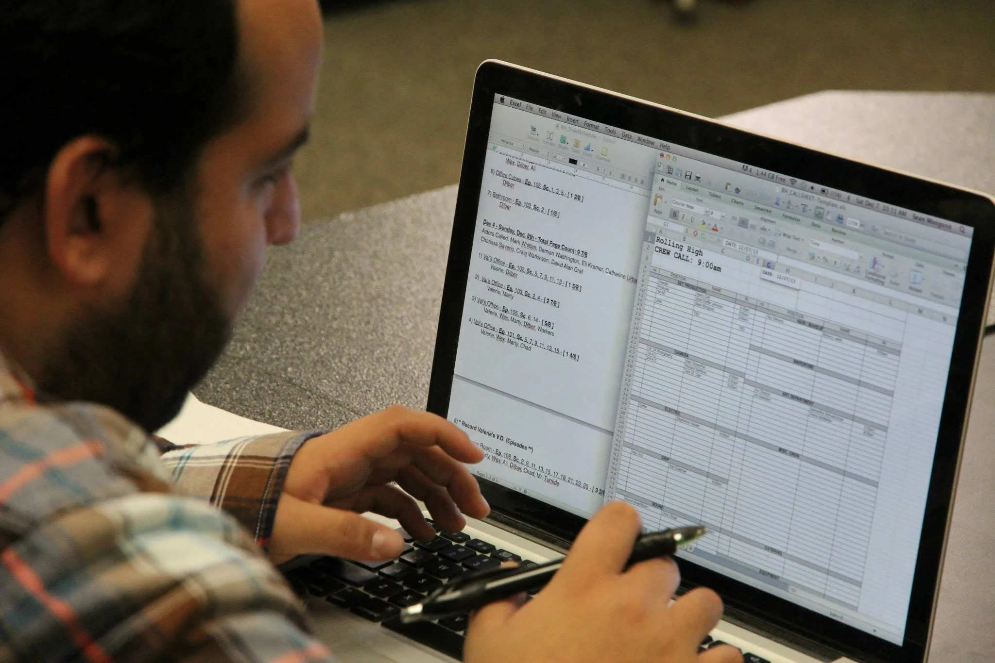 A person using a laptop with spreadsheets and documents open on the screen.