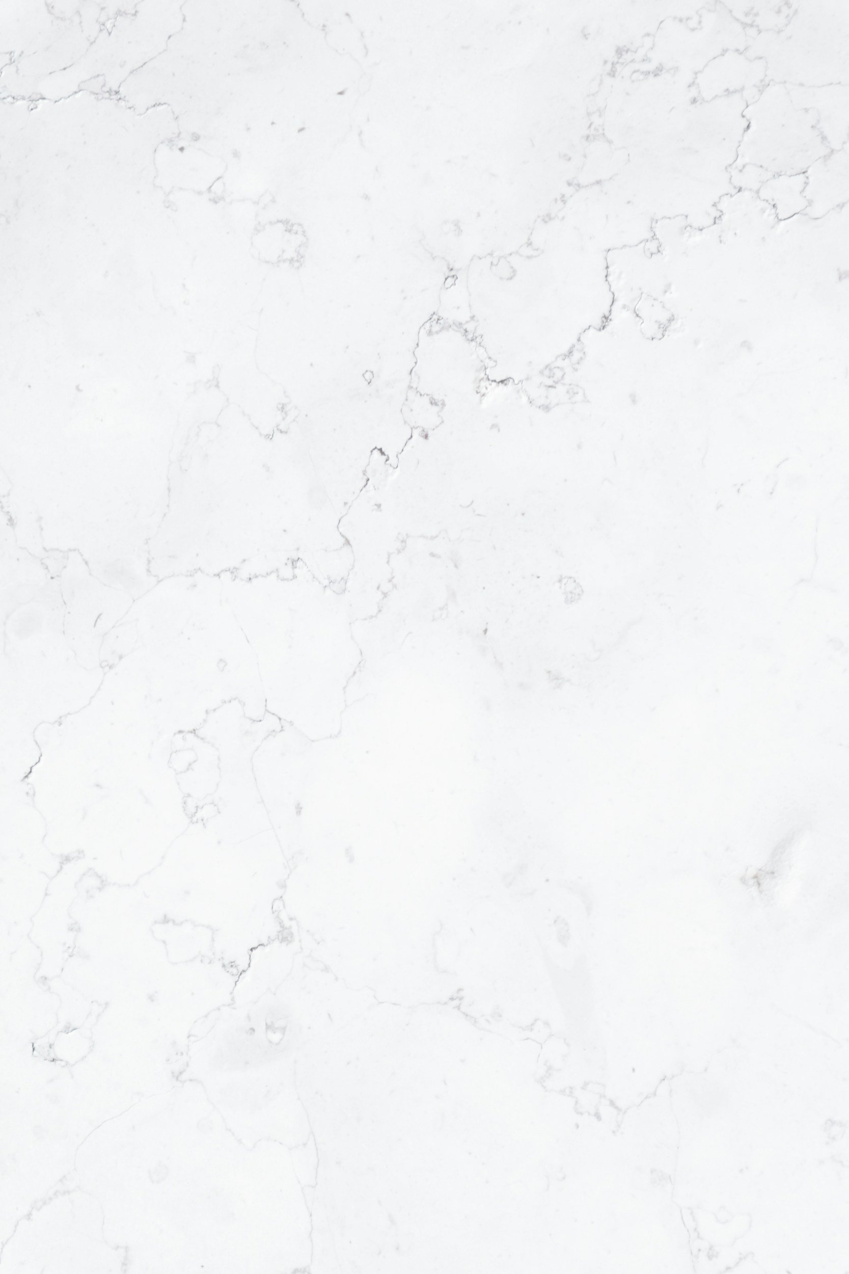 Close-up of a white marble surface with gray veining.
