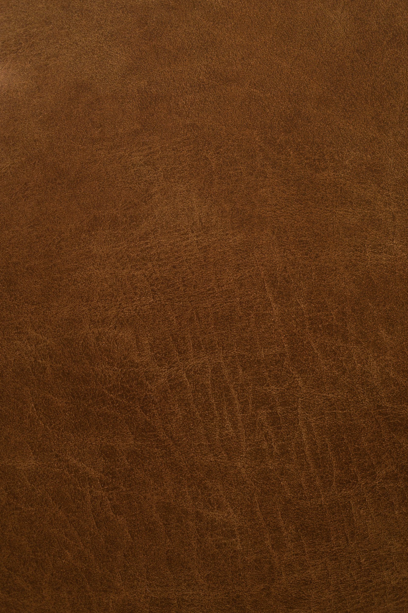 Close-up of a brown textured leather surface.