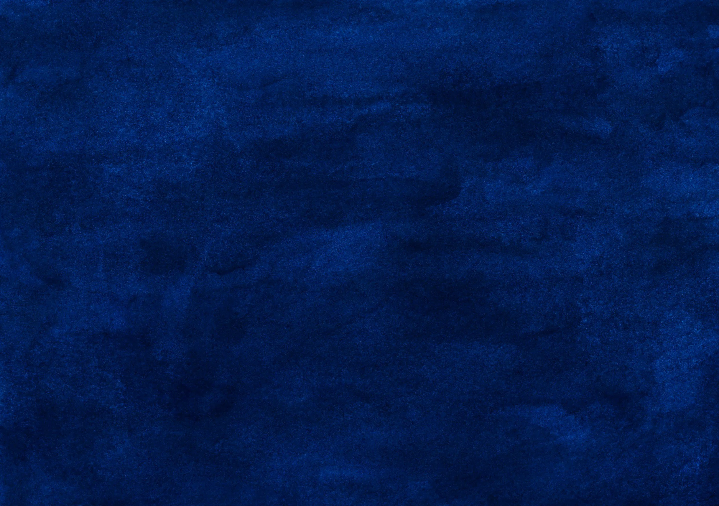 A dark blue textured surface resembling fabric or velvet.
