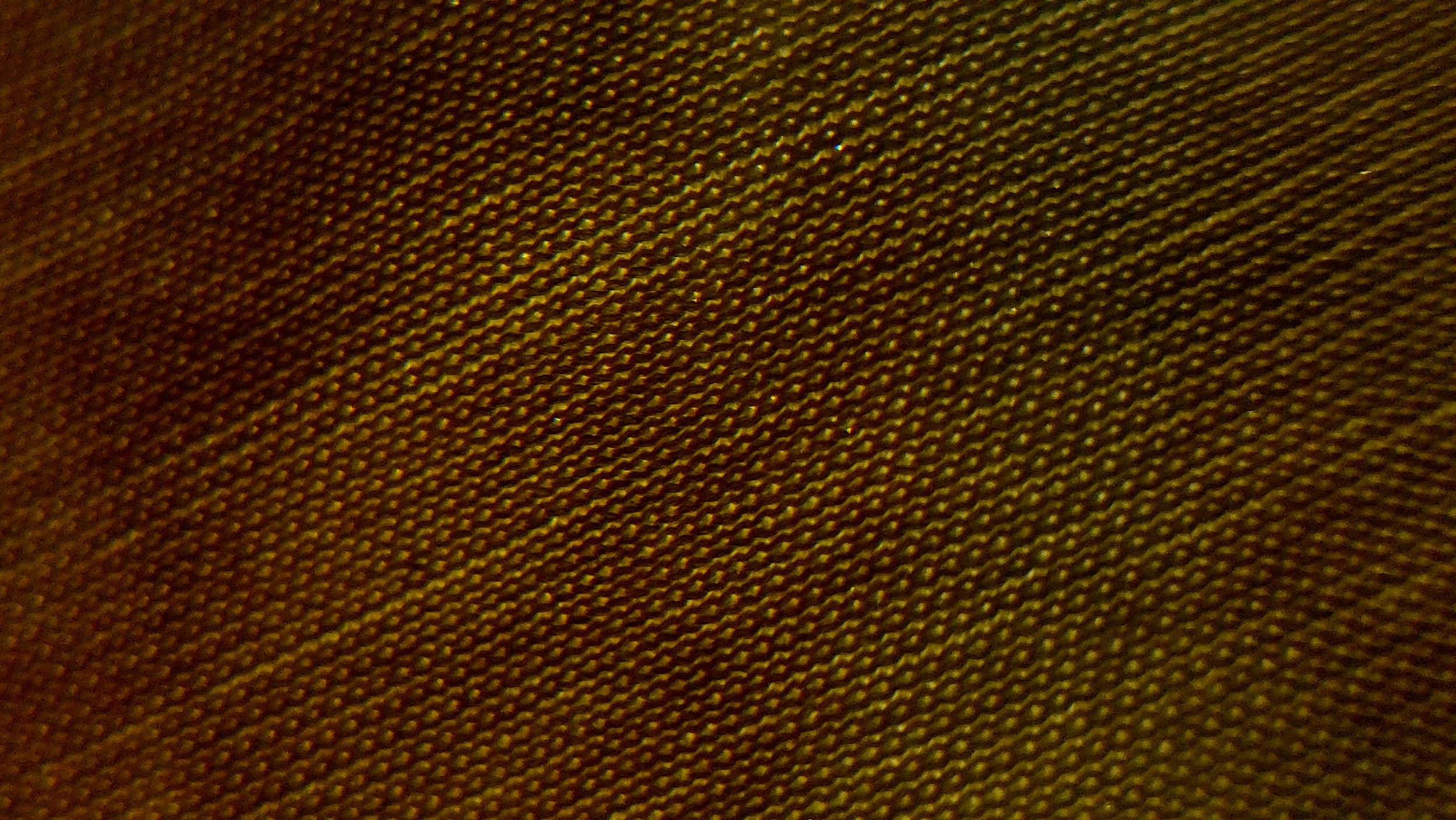 Close-up of a textured fabric with a brownish color.