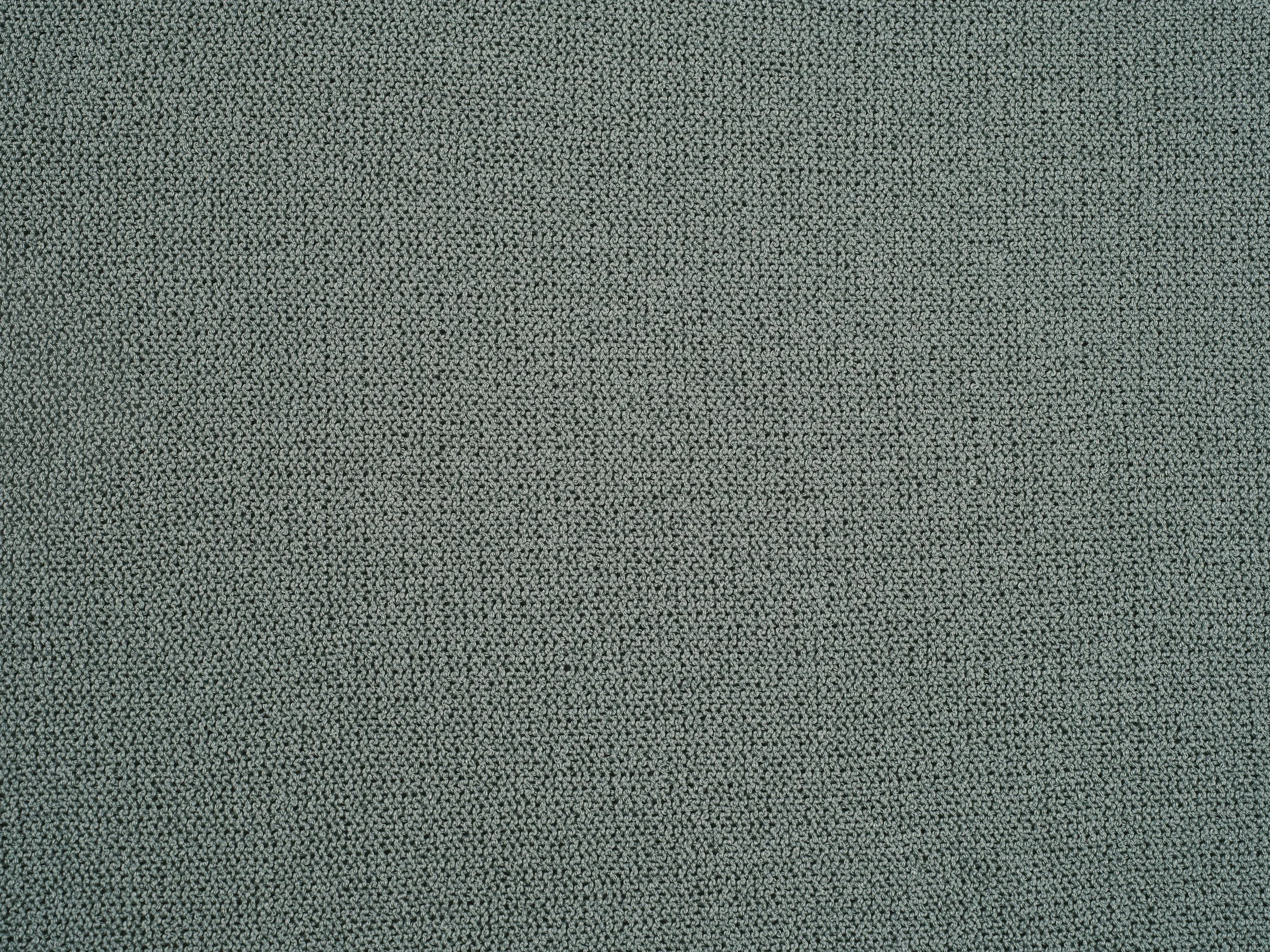 Close-up of a textured grey and black woven fabric or carpet