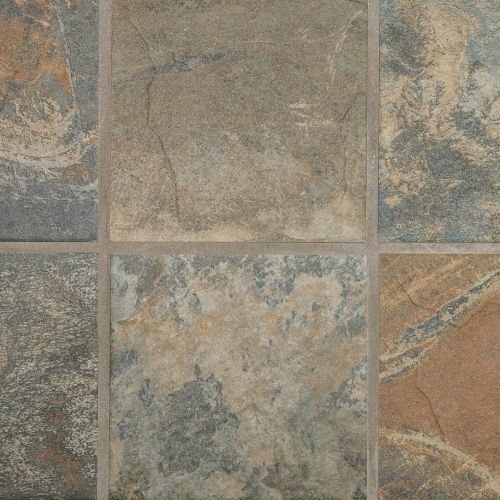 Close-up of a tiled floor with gray and tan stone tiles.