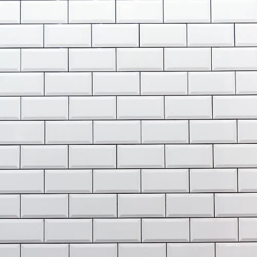 A wall of white subway tiles arranged in a horizontal pattern.