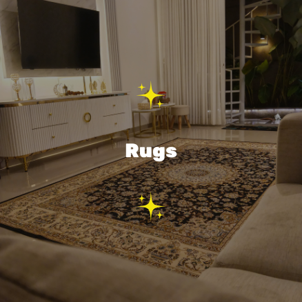 A living room with a patterned rug, a white TV console, a flat-screen TV, curtains, and a sofa.