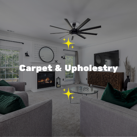 Modern living room with a fireplace, wall-mounted TV, ceiling fan, large windows, and cozy seating area with green pillows, designed for carpet and upholstery.