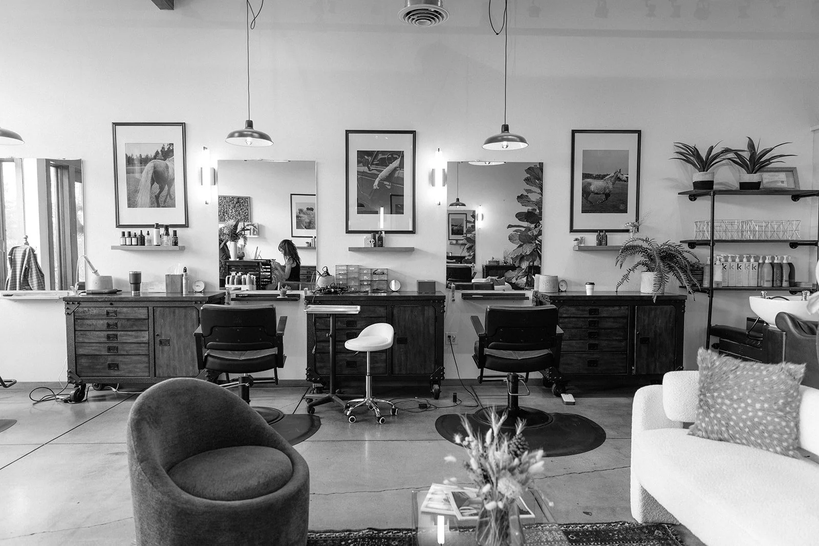 Styling stations with barber-style chairs and mirrors inside Slate hair salon in Bend, Oregon