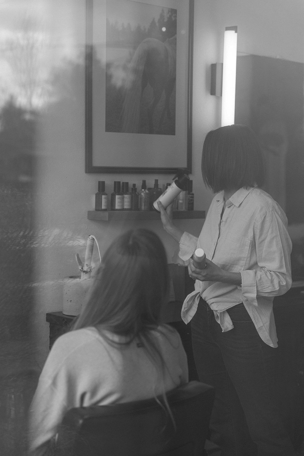 Stylist talking through a haircut with a client at Slate hair salon in Bend, Oregon