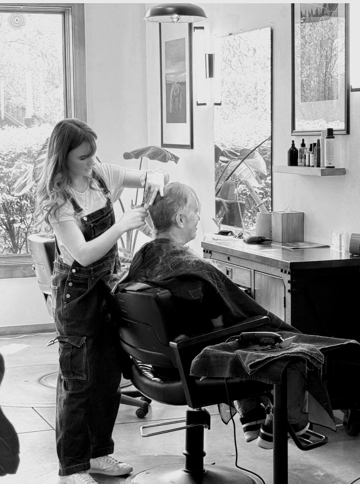 Stylist applying lived-in balayage color to a client at Slate hair salon in Bend, Oregon