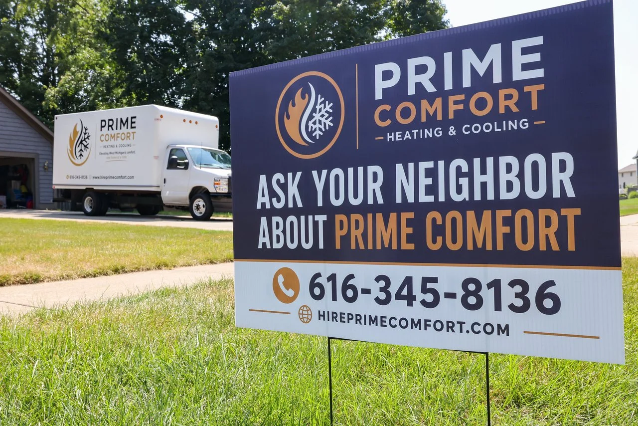 Prime Comfort yard sign at a Byron Center job site with the install truck parked behind it