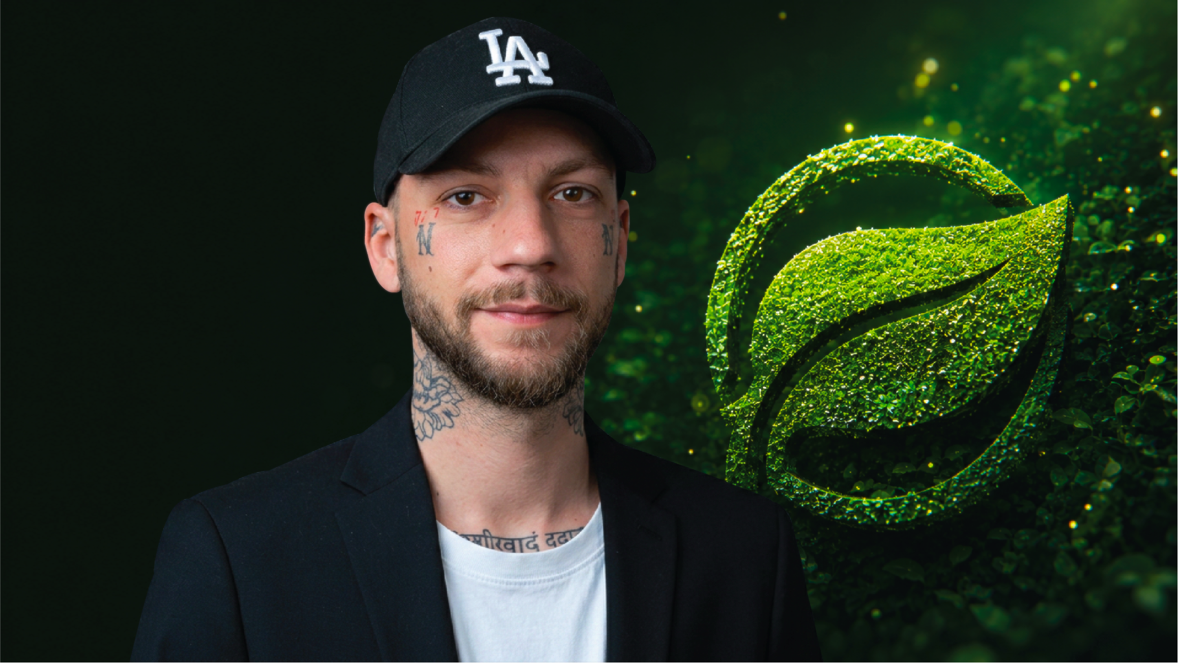 A man with tattoos on his neck and face wears a black cap with 'LA' logo and black blazer, standing in front of a digital green rose design.