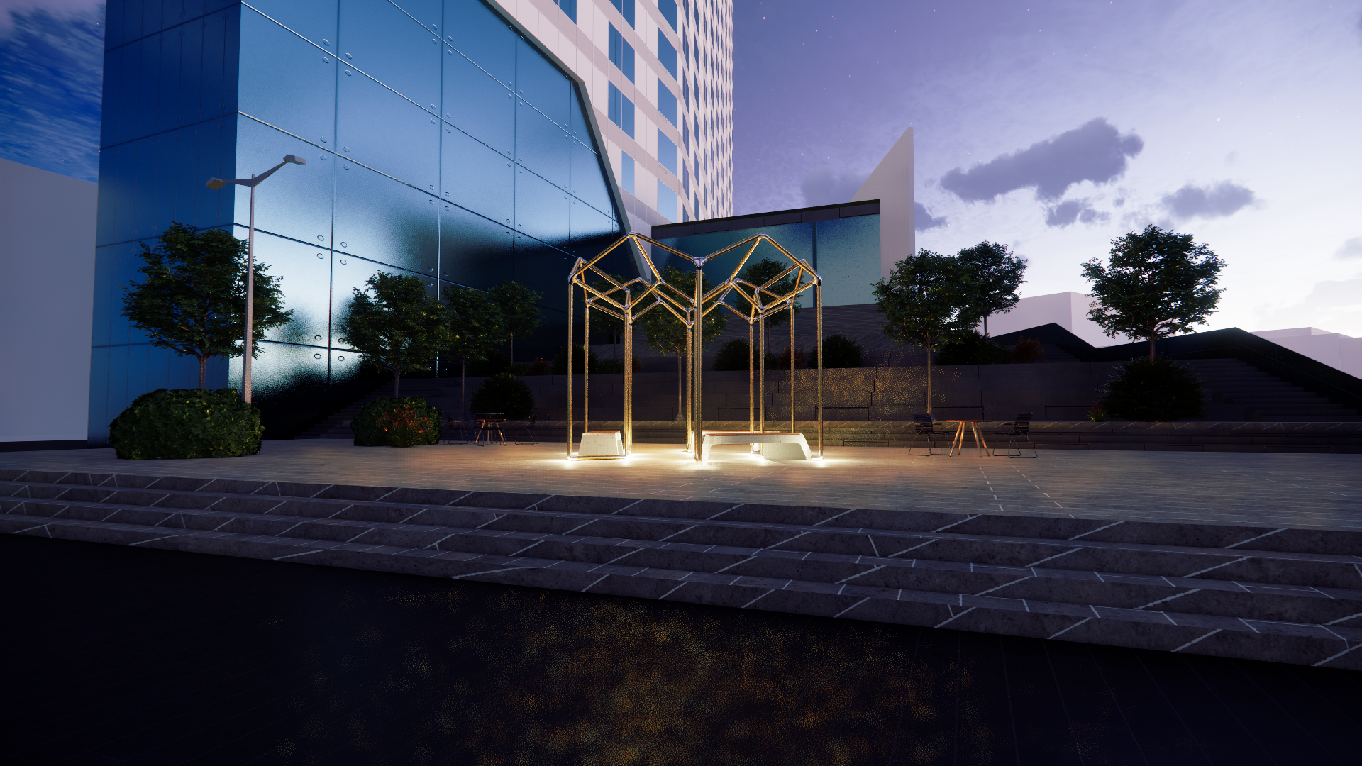 Modern building with reflective glass windows, surrounded by trees and plants, illuminated outdoor lighting, and metal art installation in an urban public space at dusk.